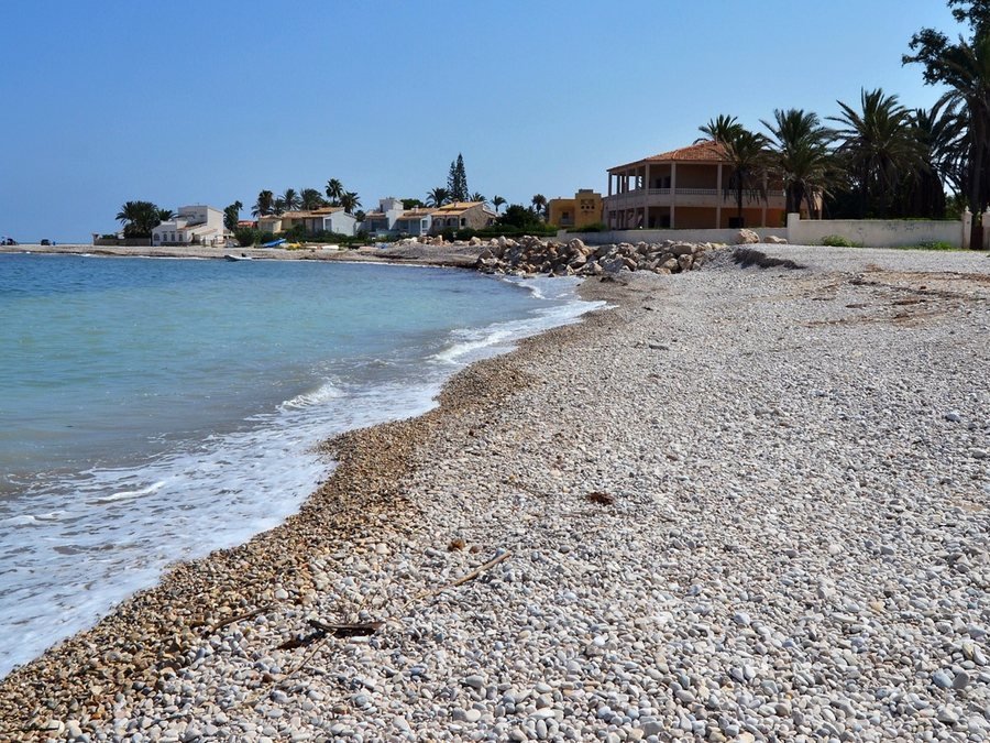 L’Almadrava beach with pebbles and clear water in Dénia